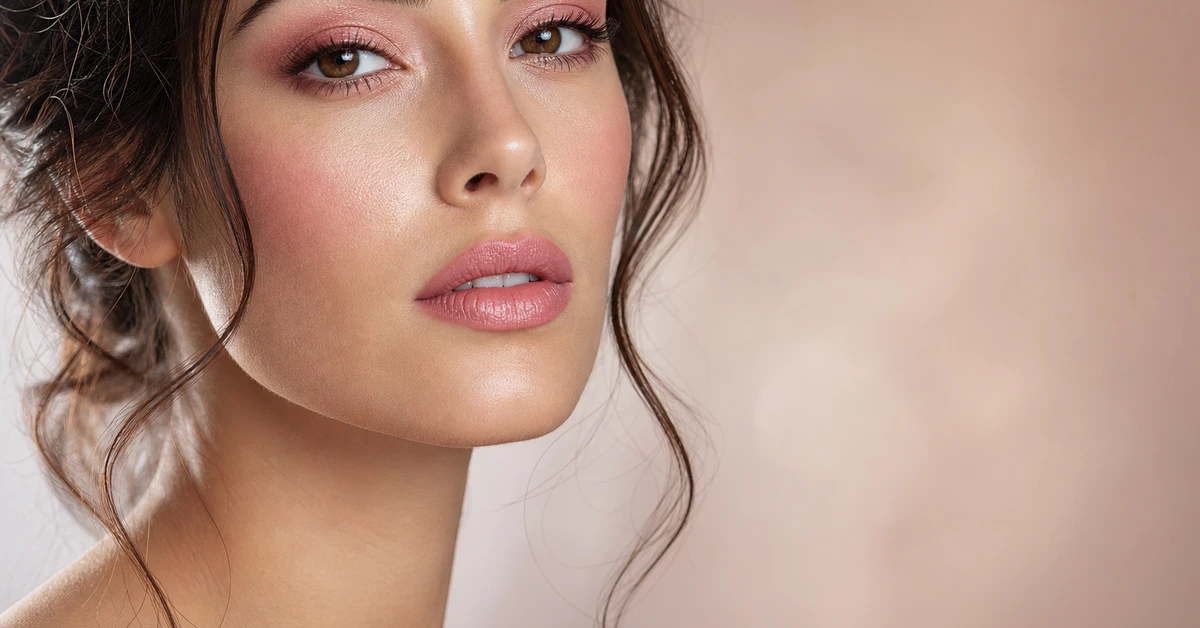 A woman wearing a warm peach blush chosen to flatter her undertone, by ToneLala