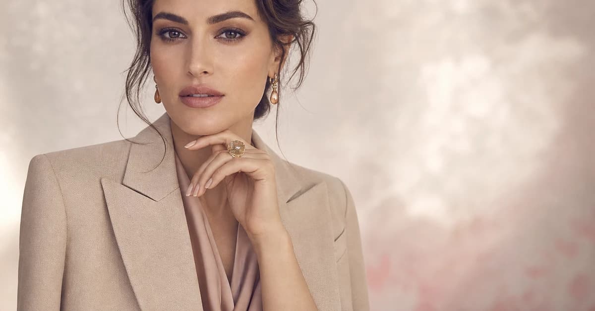 A warm beige outfit paired with a navy knit and rust accessories, with gold jewellery, by ToneLala