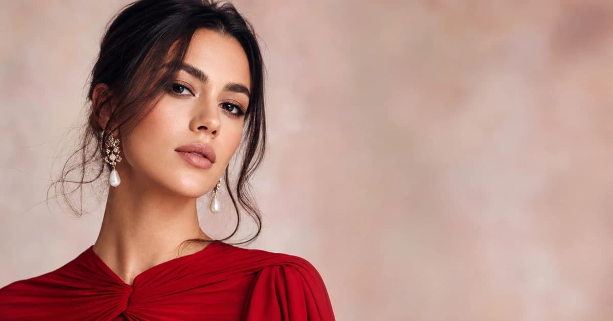 A stylish red outfit paired with navy and camel — a woman in a true-red coat over a camel jumper and navy trousers, with gold jewellery, by ToneLala