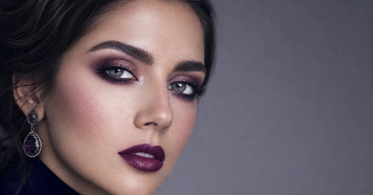 A woman wearing True Winter makeup — a cool blue-red lip, cool rose blush and charcoal-and-plum eye, by ToneLala